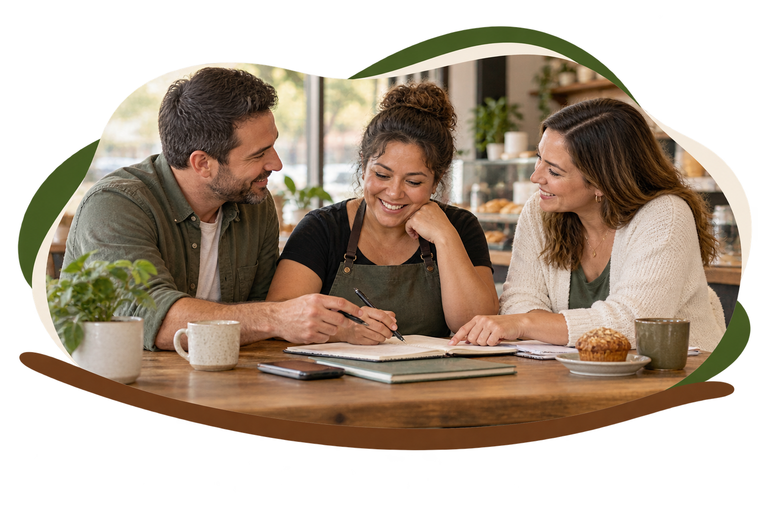 A small-business owner sits at a café table with an open notebook, smiling as two advisors — a man and a woman — lean in on either side to offer practical, friendly support.